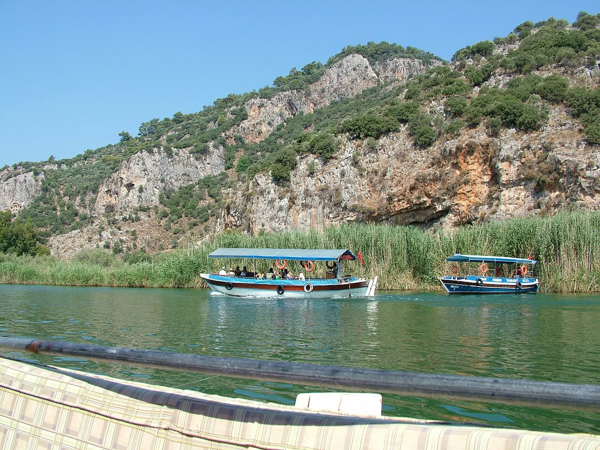 Tour boats on the Dalyan River beneath the Lycian rock tombs