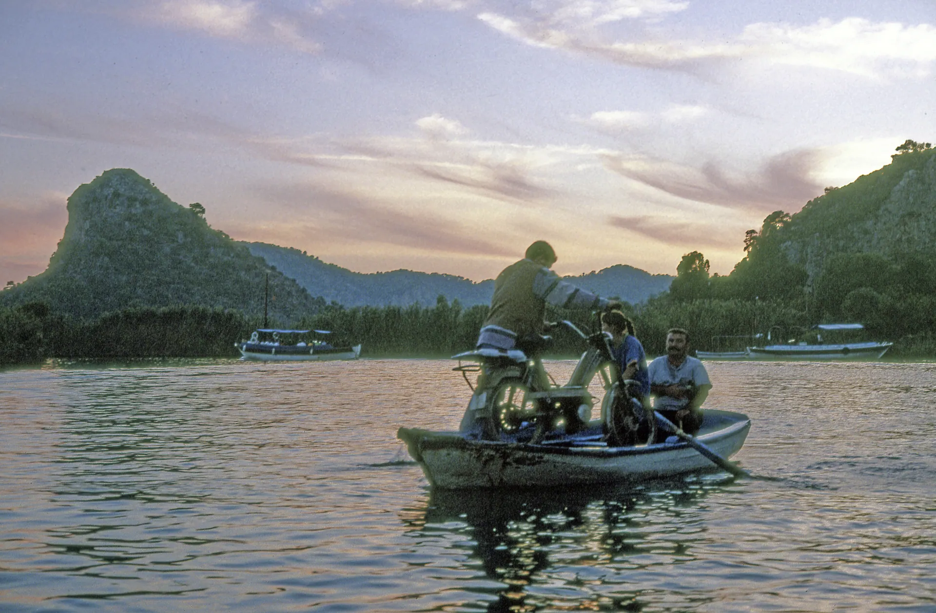 A Dalyan river boat at sunset with golden light on the water