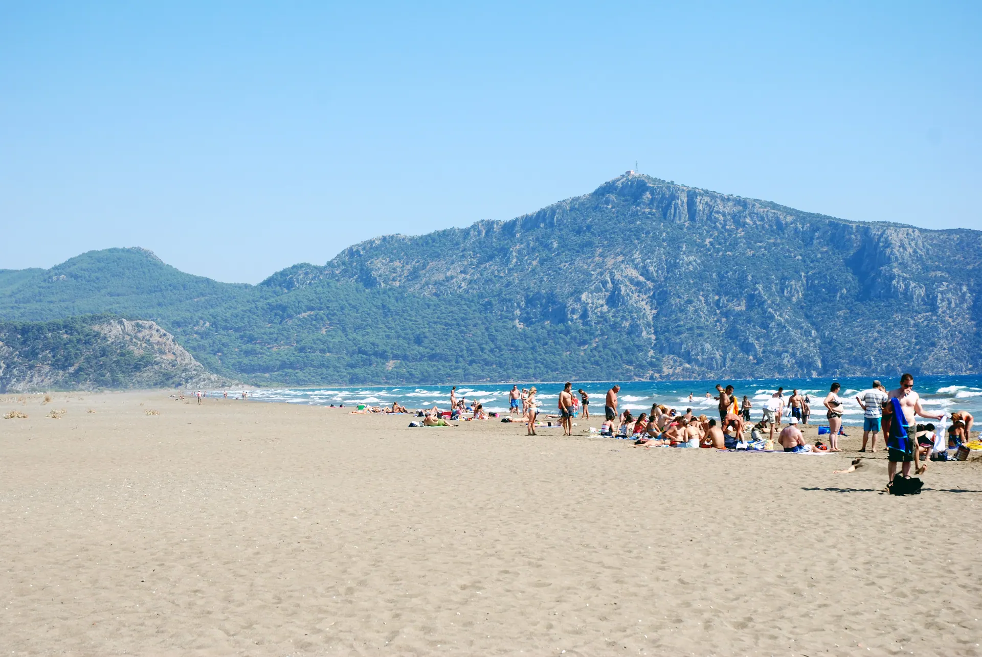 Sunbathers and swimmers on İztuzu Beach in Dalyan